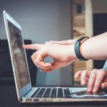man's hand pointing at computer screen, quality calls to action, new southern solutions, web design and digital solutions