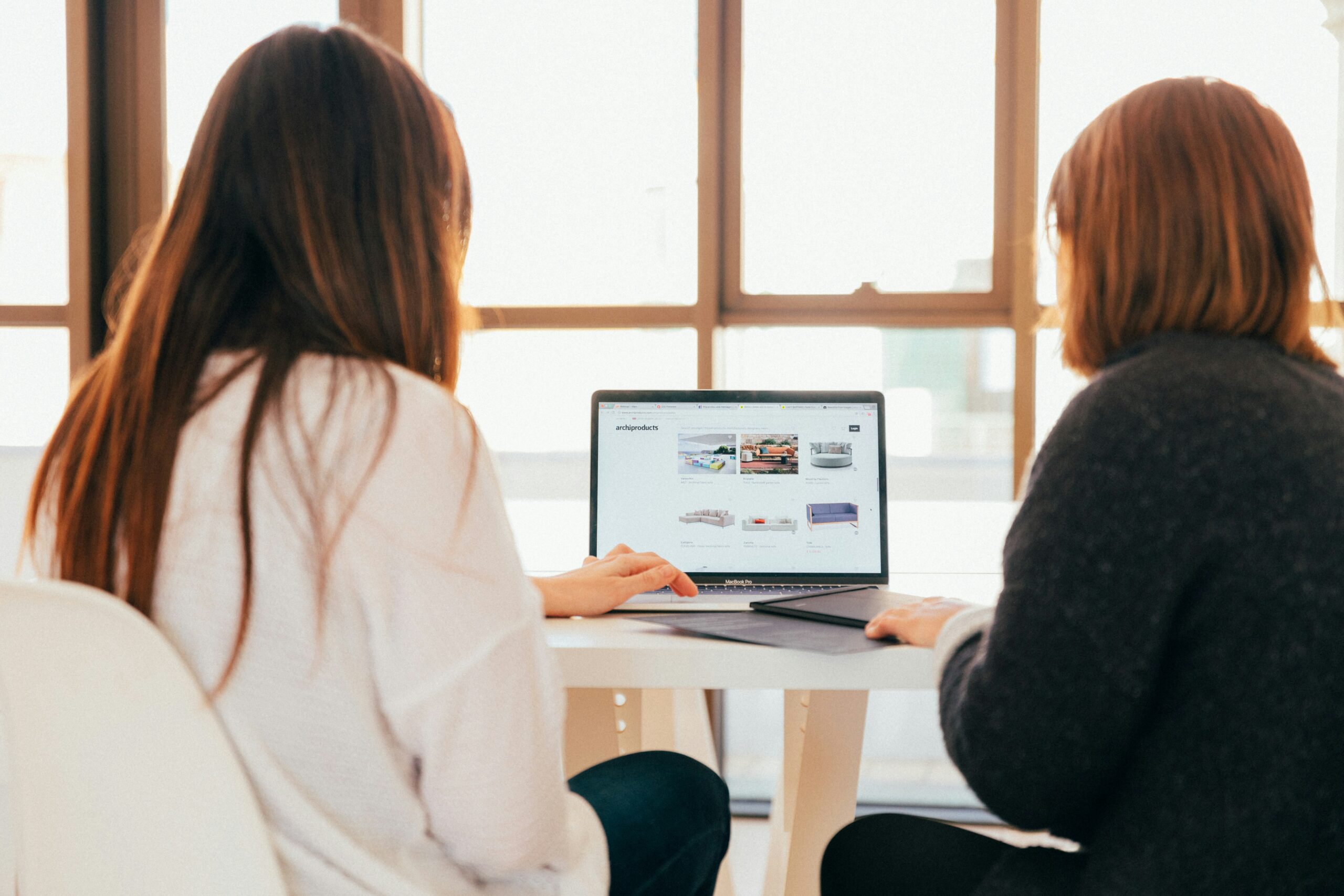 two women sitting at a laptop looking at new leads on their website, new southern solutions