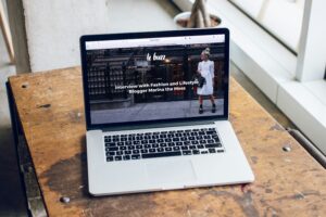 laptop sitting on coffee table open to small business website; optimize your small business website with New Southern Solutions