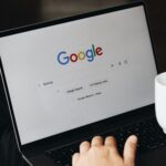 Person at computer with webpage open to google; google business page optimization for businesses; new southern solutions