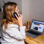 woman on the phone sitting at a computer, calling a business from their website contact form, new southern solutions