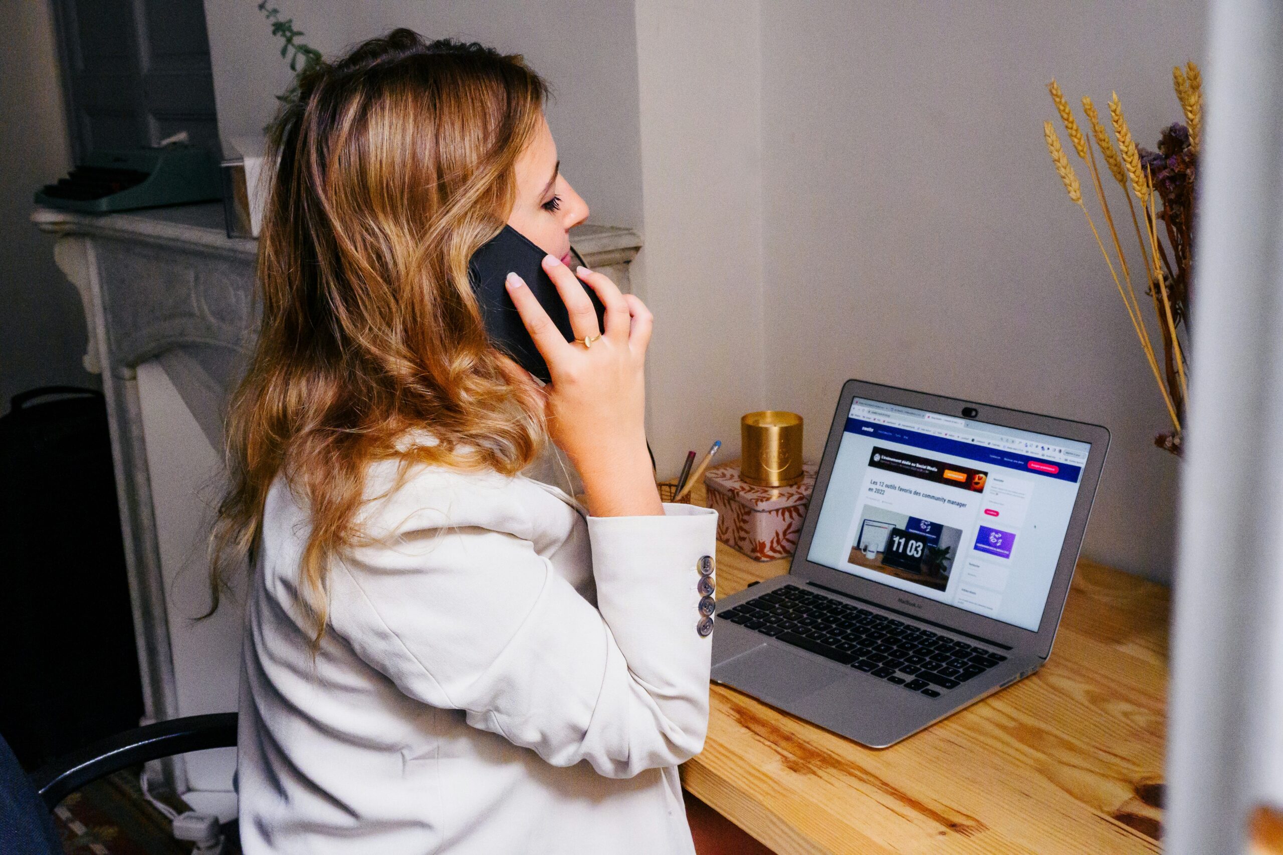 woman on the phone sitting at a computer, calling a business from their website contact form, new southern solutions